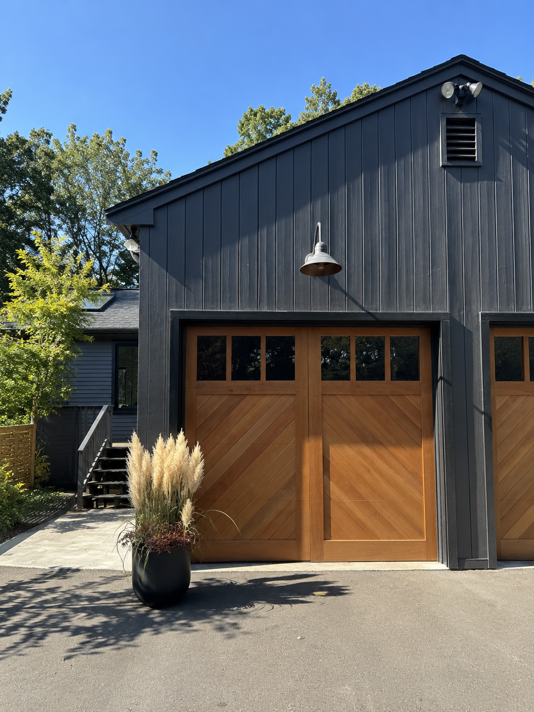 Warm wood-tone craftsman garage door on a historic Brown Shingle home in the Berkeley Hills